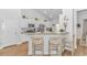 Kitchen with breakfast bar, white cabinets, stainless steel appliances, and granite countertops at 935 Piping Plover Ln., Myrtle Beach, SC 29577