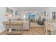 Living room with wood floors, large TV, and view into the adjacent kitchen at 935 Piping Plover Ln., Myrtle Beach, SC 29577