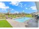 In-ground pool with a paved patio, lush lawn, and fenced backyard at 935 Piping Plover Ln., Myrtle Beach, SC 29577