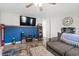 Living room with gray sectional sofa, a large TV, and a blue accent wall at 1108 Blue Juniper Ct., Conway, SC 29527