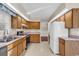 Bright kitchen with oak cabinets, pink countertops, and stainless steel appliances at 248 Cottonwood Ln., Conway, SC 29526