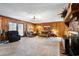 Living room featuring a brick fireplace, wood paneled walls, and comfy seating at 291 Frances Parker Rd., Georgetown, SC 29440