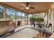 Relaxing screened porch with outdoor seating and grill, overlooking a wooded area at 291 Frances Parker Rd., Georgetown, SC 29440