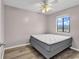 Bright bedroom featuring a comfortable double bed and ceiling fan at 301 N Waccamaw Dr. # 109, Garden City Beach, SC 29576
