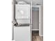 Stackable washer and dryer in a compact laundry room at 301 N Waccamaw Dr. # 109, Garden City Beach, SC 29576