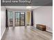 Living room featuring new flooring and access to balcony at 301 N Waccamaw Dr. # 109, Garden City Beach, SC 29576