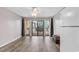 Living room with new flooring and access to balcony at 301 N Waccamaw Dr. # 109, Garden City Beach, SC 29576