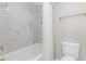 Updated bathroom with marble tile and a white bathtub at 403 71St Ave. N # 12, Myrtle Beach, SC 29572