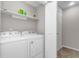 Laundry closet with washer, dryer, and shelving at 403 71St Ave. N # 12, Myrtle Beach, SC 29572