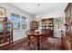 Formal dining room with hardwood floors, a round table, and china cabinet at 405 Cypress Springs Way, Little River, SC 29566