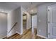 Upstairs hallway with hardwood floors and access to laundry and bedrooms at 4056 Bucolic Loop, Myrtle Beach, SC 29588