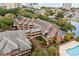 Aerial view of building exterior, highlighting architectural details and pool at 410 Melrose Pl. # 210, Myrtle Beach, SC 29572