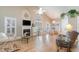 Bright living room with hardwood floors, fireplace, and vaulted ceiling at 422 Nature Trail Dr., Little River, SC 29566