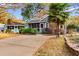 Gray house with brick chimney, screened porch, and landscaped yard at 4306 Frontier Dr., Myrtle Beach, SC 29577