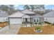 Single-story home with stone accents and a two-car garage at 4551 Day Lily Run St., Myrtle Beach, SC 29579