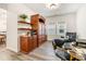 Home office with built-in shelving and a comfortable armchair at 4551 Day Lily Run St., Myrtle Beach, SC 29579