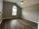 Bedroom with gray walls, wood-look floors, and arched window at 4670 Southgate Pkwy., Myrtle Beach, SC 29579