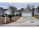 Beige house with a white garage door and landscaping at 4670 Southgate Pkwy., Myrtle Beach, SC 29579