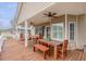 Spacious deck with wooden table and chairs, ceiling fan at 6001-1886 S Kings Hwy., Myrtle Beach, SC 29575