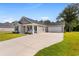 Gray house with a driveway, lawn, and trees in the background at 612 Pine Oaks Farm Rd., Aynor, SC 29511