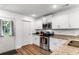 Modern kitchen with white cabinets, granite countertops, and stainless steel appliances at 612 Pine Oaks Farm Rd., Aynor, SC 29511