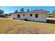 Side view of the house showcasing the white brick exterior and landscaping at 90 Wateree Trail, Georgetown, SC 29440