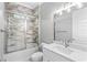 Elegant bathroom with marble tile, quartz vanity, and walk-in shower at 1017 Muscovy Pl., Conway, SC 29526