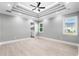 Main bedroom with tray ceiling, hardwood floors and ensuite bathroom at 1017 Muscovy Pl., Conway, SC 29526