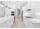 Open concept kitchen boasts white cabinetry, stainless steel appliances, and quartz countertops at 1017 Muscovy Pl., Conway, SC 29526