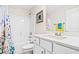 Bathroom features a floral shower curtain and a white vanity at 1276 Marsilio Ln Sw, Ocean Isle Beach, NC 28469