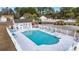 Community pool with surrounding lounge chairs and fenced area at 2016 Neath Ct., Myrtle Beach, SC 29588