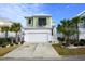 Two-story house with green and white exterior, white garage door, and landscaping at 244 Splendor Circle, Murrells Inlet, SC 29576