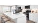 Modern kitchen with white cabinets, stainless steel appliances, and a large island at 317 Bent Green Ct. # 84B, Murrells Inlet, SC 29576