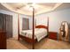 Main bedroom with wood post bed and light blue walls at 4530 Lighthouse Dr. # 31-C, Little River, SC 29566