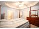 Main bedroom with wood post bed, ensuite bathroom, and access to other rooms at 4530 Lighthouse Dr. # 31-C, Little River, SC 29566