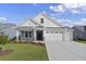 Two-story home with white siding, brick accents, and a two-car garage at 5035 Cambria Ct., Little River, SC 29566