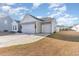 Two-car garage with light gray siding and two white garage doors at 5037 Sassari St., Myrtle Beach, SC 29579