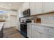 Modern kitchen featuring white cabinets, stainless steel appliances, and quartz countertops at 527 Slaty Dr., Myrtle Beach, SC 29588