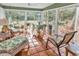 Sunroom with terracotta tile floor, wicker furniture, and leafy plants at 5532 Springs Ave., Myrtle Beach, SC 29577