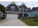 Two-story home with gray siding, stone accents, and a two-car garage at 562 Haven View Way, Murrells Inlet, SC 29576