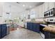 Modern kitchen with blue cabinets, granite counters, and stainless steel appliances at 8201 Caddis Ct., Myrtle Beach, SC 29579