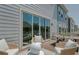 Relaxing deck with wicker furniture and glass doors leading to the interior at 8465 Waltzing Waves Ct. # 26, Myrtle Beach, SC 29572
