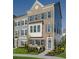 Three-story townhouse with brick front, gray siding, and a gray door at 8465 Waltzing Waves Ct. # 26, Myrtle Beach, SC 29572