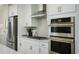 Sleek kitchen features stainless steel appliances and white cabinetry at 8474 Duke Pl. # 31, Myrtle Beach, SC 29572