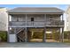 Elevated beach house with ocean views, deck, and stairs at 943 Ocean Blvd., Holden Beach, NC 28462