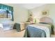 Two twin beds in a bright bedroom with light green walls and window at 9501 Shore Dr. # D-235, Myrtle Beach, SC 29572