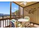 Screened balcony with table and chairs, partial ocean view at 9501 Shore Dr. # D-235, Myrtle Beach, SC 29572