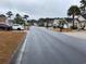 Residential street lined with houses and palm trees at 957 Bellflower Dr., Longs, SC 29568