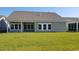 Gray house with covered patio, large backyard, and mature lawn at Lot 729 Zoe Way, Myrtle Beach, SC 29588