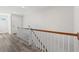 Upper-level hallway with hardwood floors and a wooden staircase at Tbd Mud Minnow Dr., Pawleys Island, SC 29585